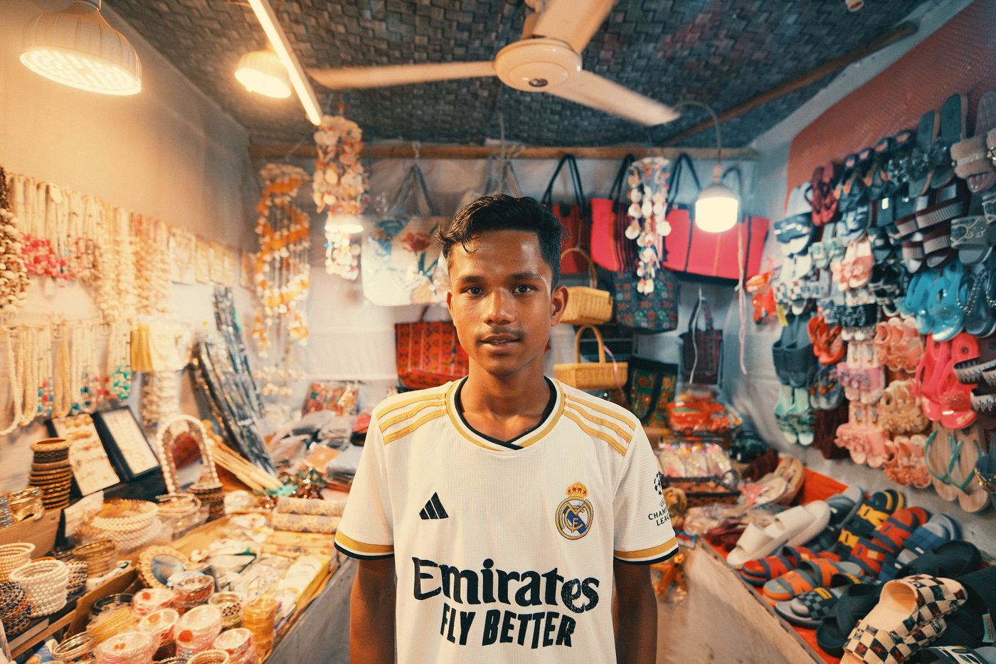 A shop owner arranging accessories on a display counter