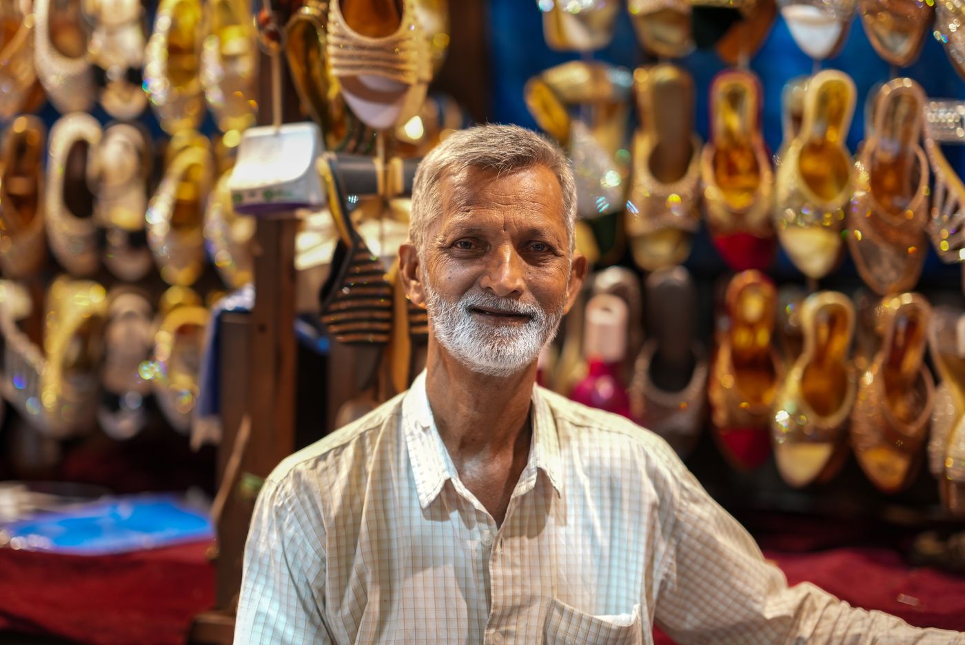A footwear shop owner among boxes of stock